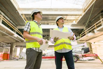 two-business-builder-people-at-construction-site-2022-01-14-00-09-26-utc