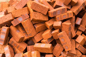 heaps-of-red-clay-bricks-at-construction-site-2021-09-01-23-18-00-utc