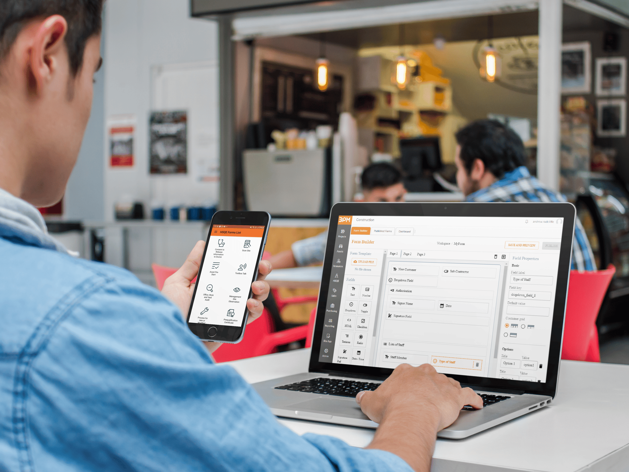 iphone-and-macbook-mockup-of-a-young-man-at-the-cafeteria-a4635